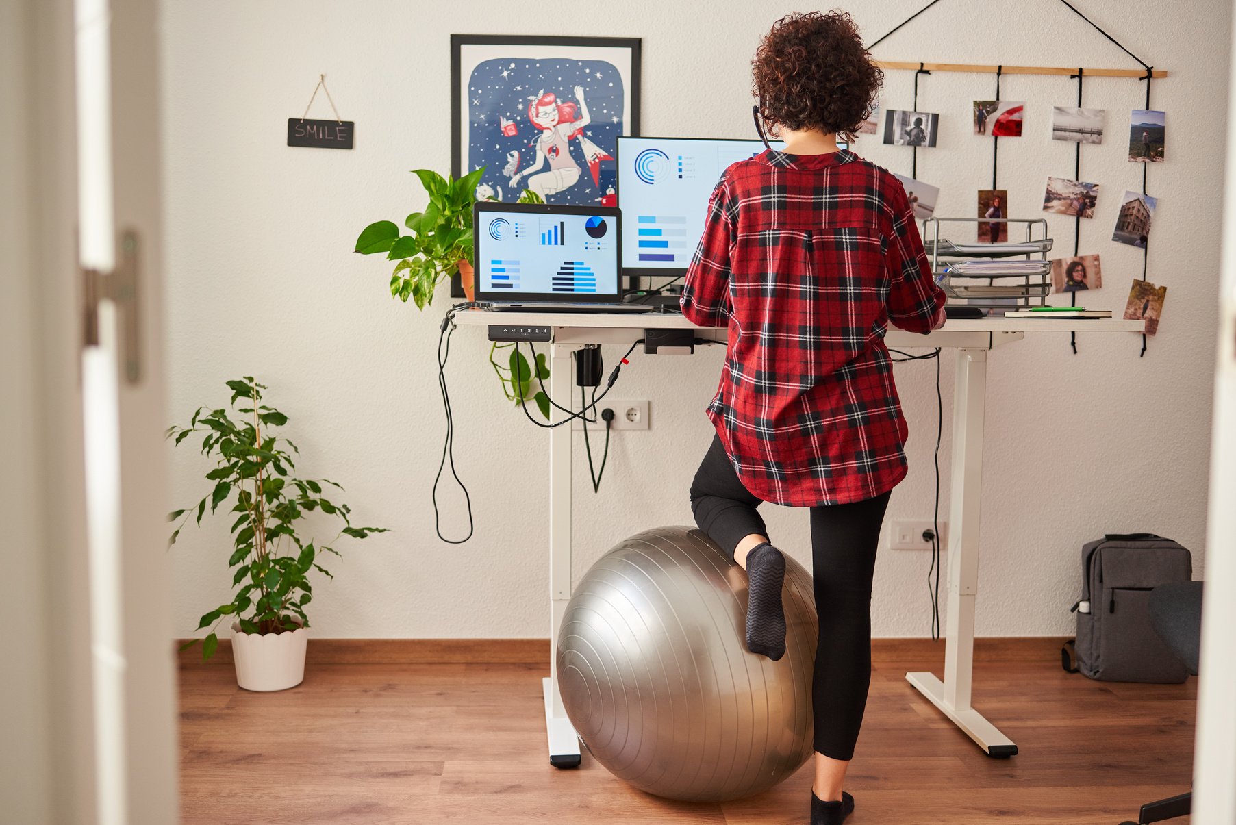 Woman Working with an Adjustable Height Desk and Fit Ball